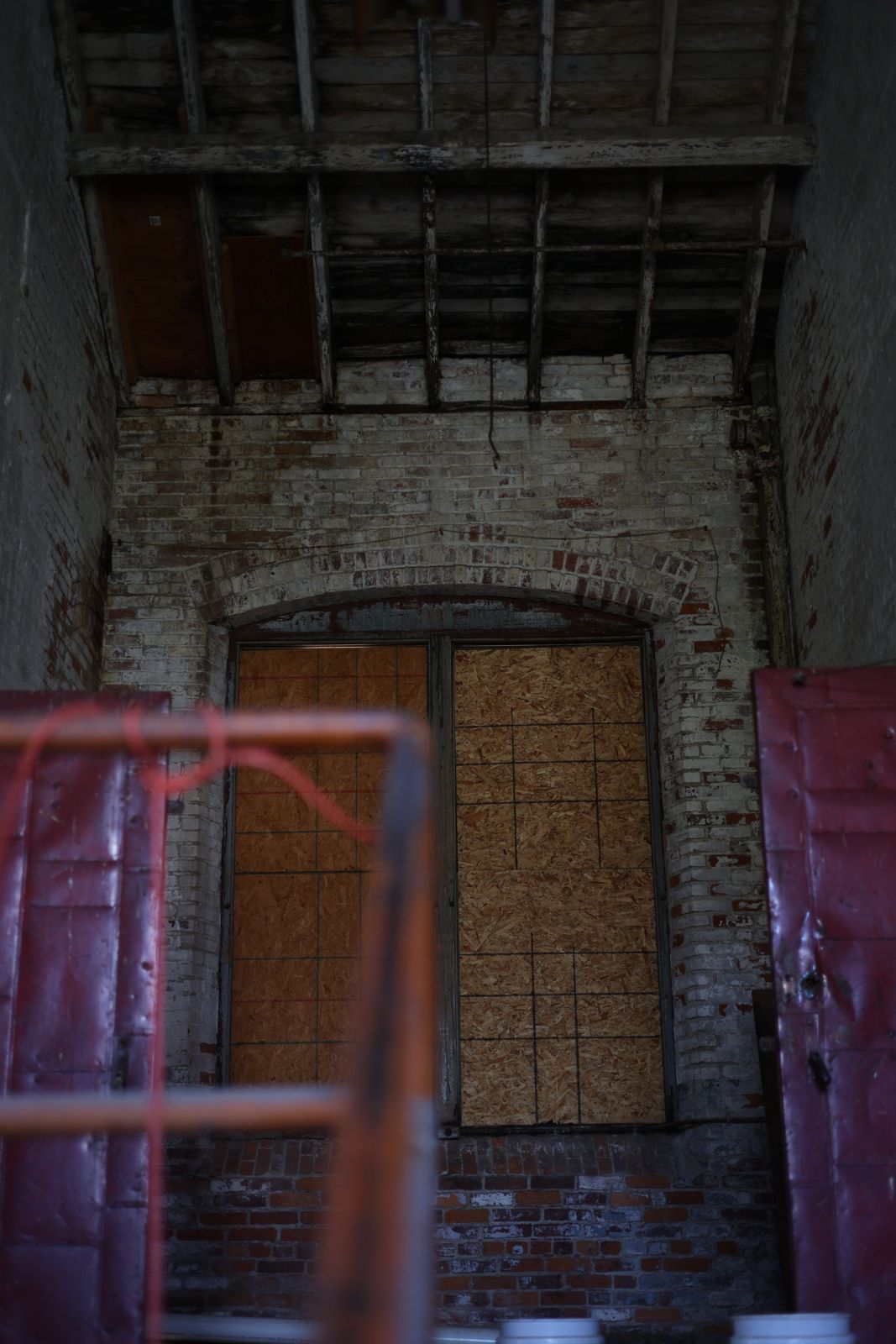 Boarded arched window in the shaftway stair