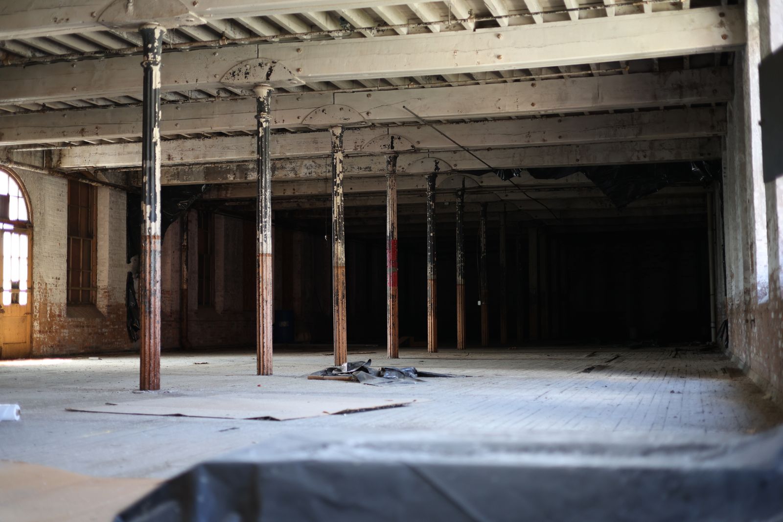 Column-lined floor with an arched brick entry