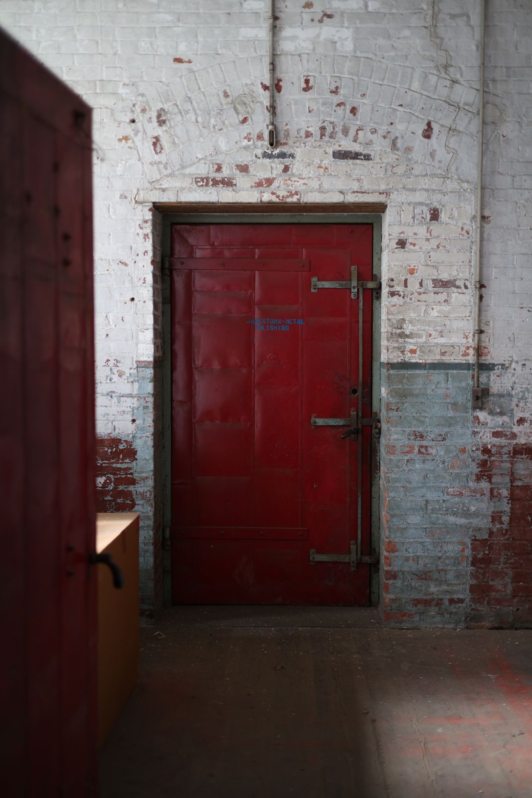 Steel fire door set into original brick
