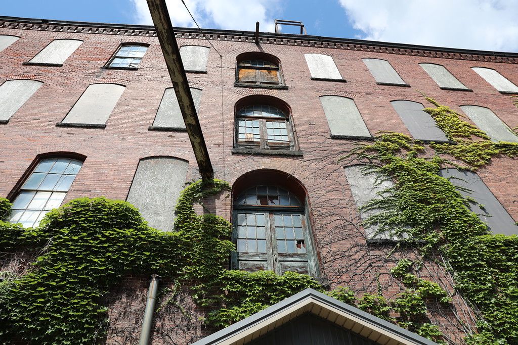 Boarded upper-floor windows on the courtyard elevation
