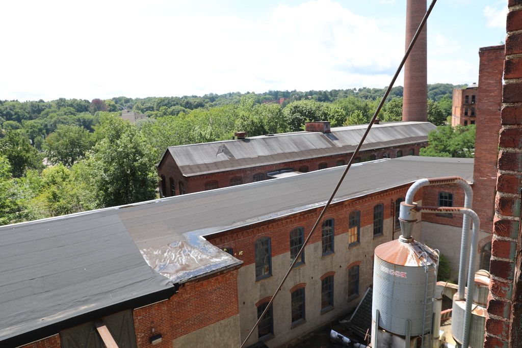 Silo and stack rising from a low roof