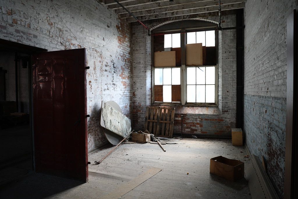 Back room with a broken window and stored materials