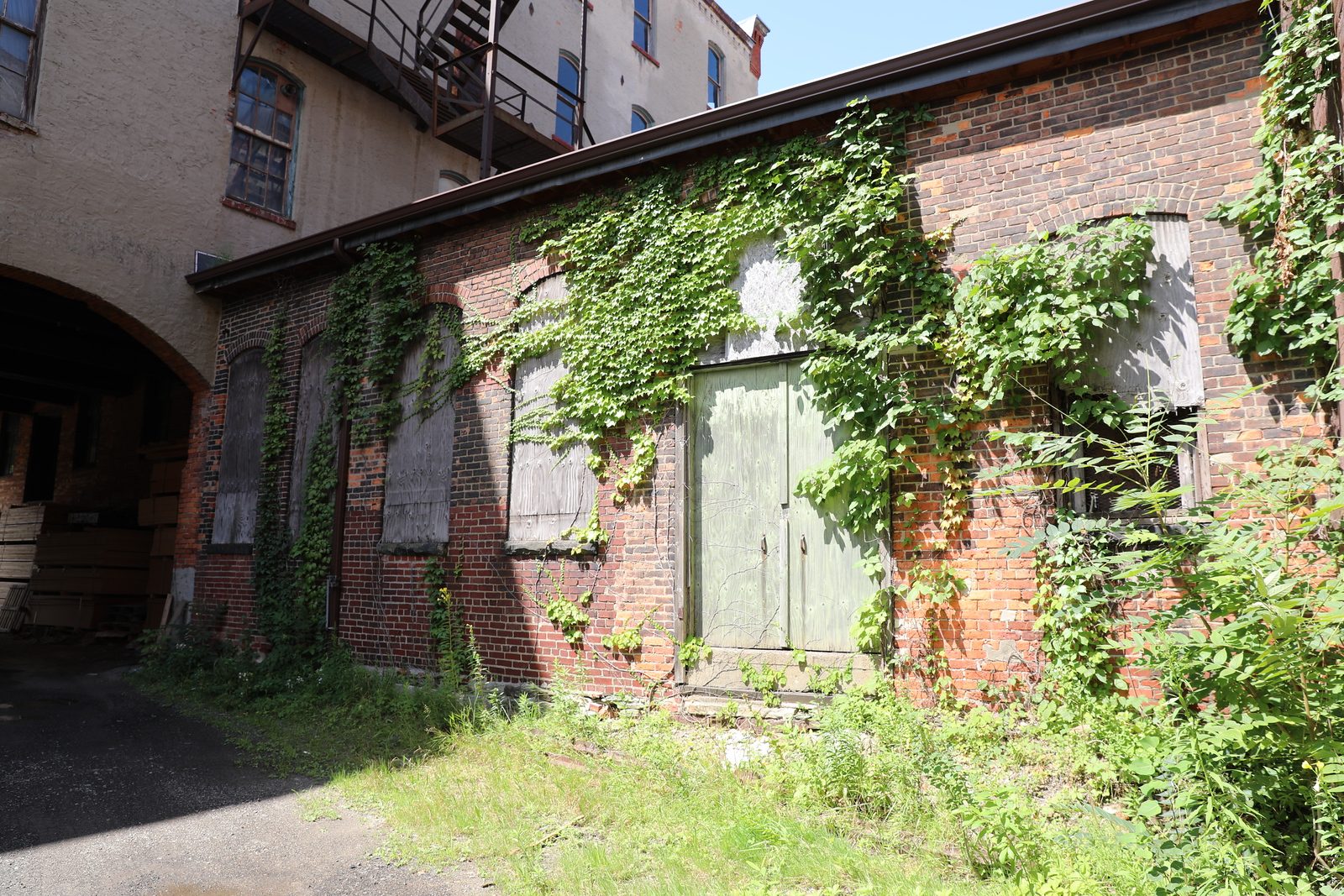 Ivy-covered rear elevation with boarded windows