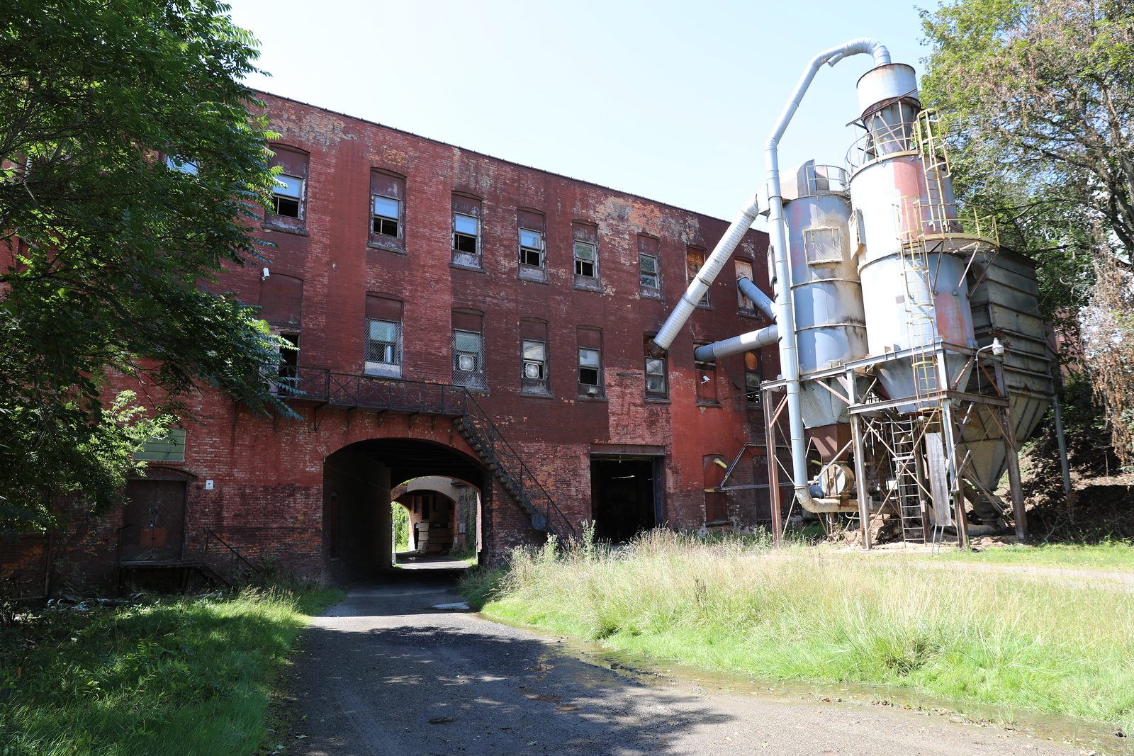 Rear elevation with an archway and industrial silo equipment