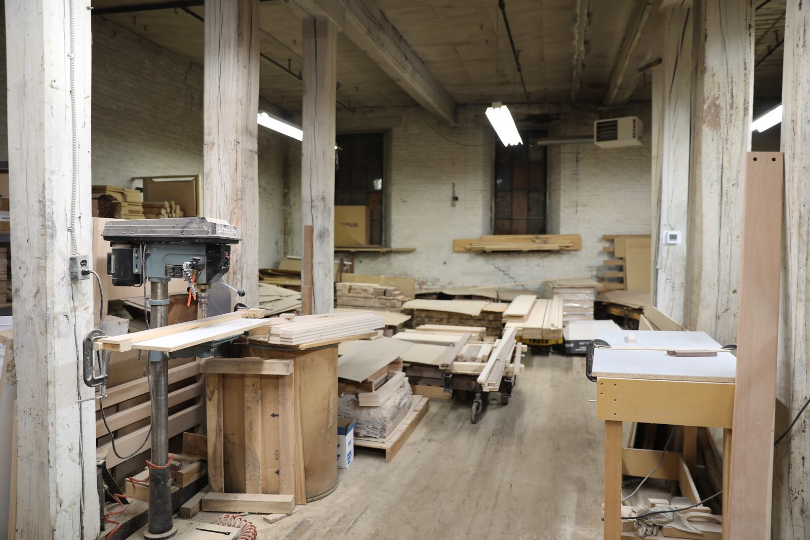 Workbenches and stacked stock in the shop