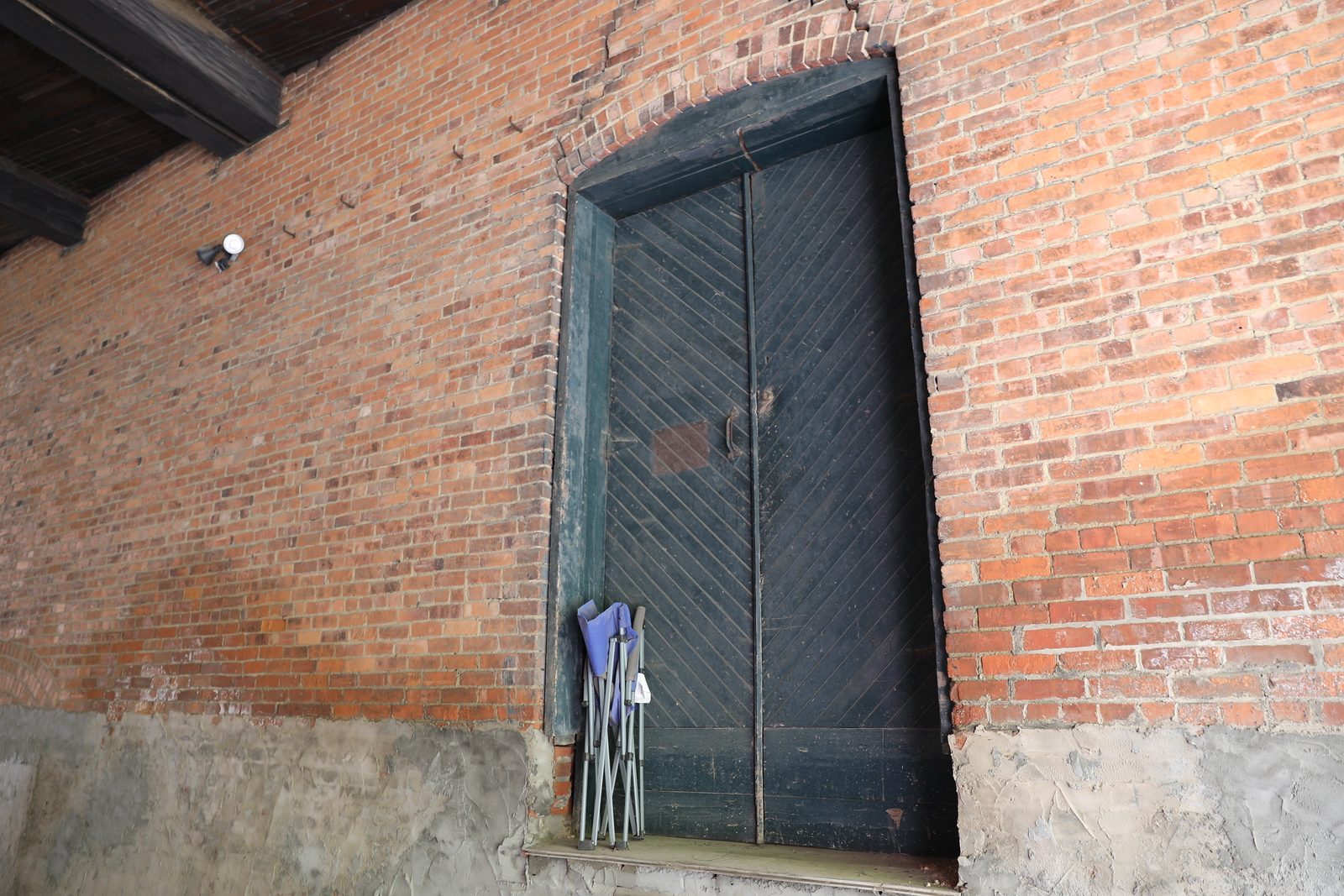 Dark wood door set into a brick wall